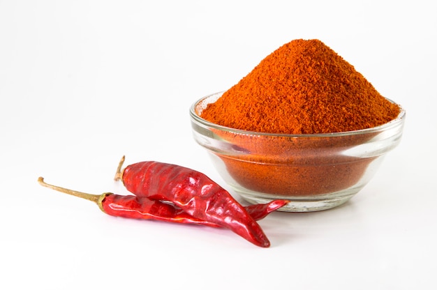 Chilli powder in a bowl with red dried chillies