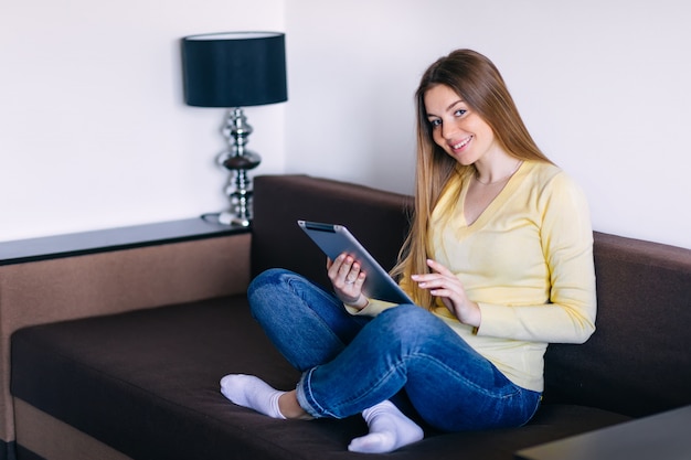 Chilling gorgeous freelancer on the beige couch at home