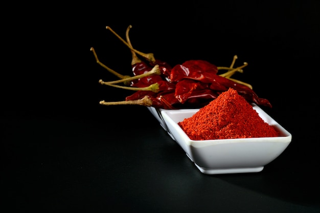 Chilly powder with red chilly in white plate, dried chillies