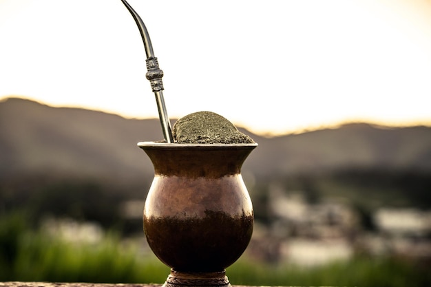 The chimarrao or mate is a drink produced by infusing the yerba mate plant in boiling water in a bowl with a pump traditional for winter in South America