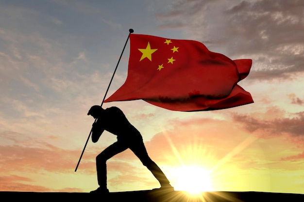 男性のシルエット3Dレンダリングによって地面に押し込まれている中国の旗