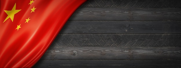 China flag on black wood wall. Horizontal panoramic banner.