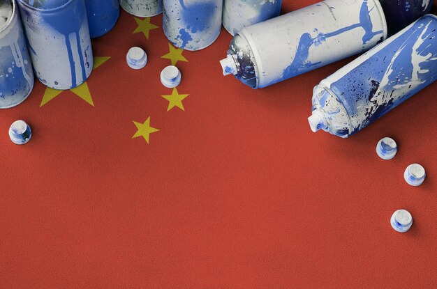 China flag and few used aerosol spray cans for graffiti painting Street art culture concept