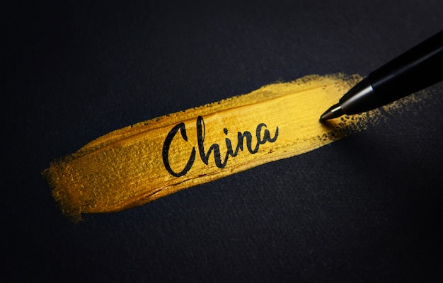 China Handwriting Text on Golden Paint Brush Stroke