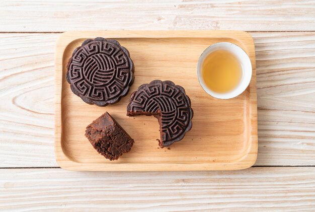 Chinees donkere de chocoladesmaak van de maancake op houten plaat