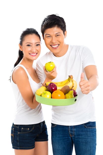 Chinese Asian couple eating healthy fruits