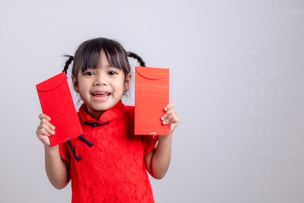 Chinese baby girl traditional dressing up with a FU means lucky red envelope
