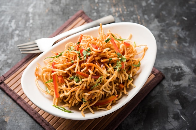 Chinese Bhel is a spicy indo-chinese recipe, served in a bowl. selective focus