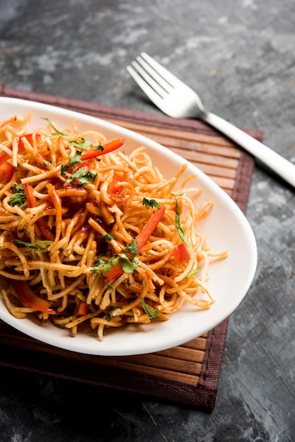 Chinese Bhel is a spicy indo-chinese recipe, served in a bowl. selective focus