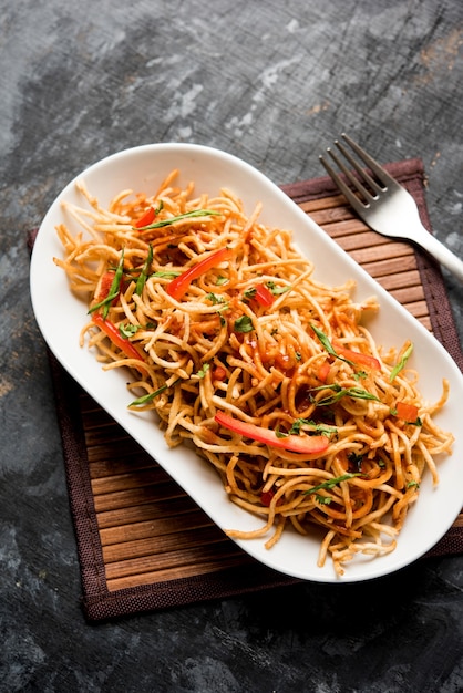 Chinese Bhel is a spicy indo-chinese recipe, served in a bowl. selective focus