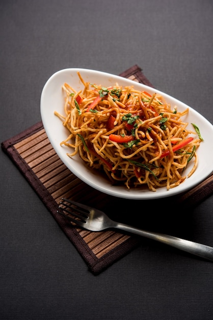 Chinese Bhel is a spicy indo-chinese recipe, served in a bowl. selective focus