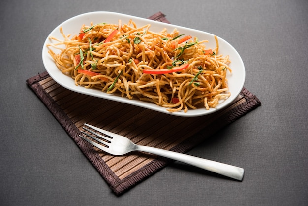 Chinese Bhel is a spicy indo-chinese recipe, served in a bowl. selective focus