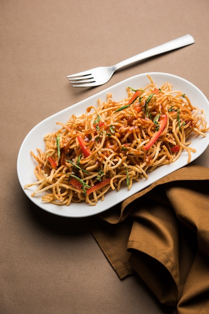 Chinese Bhel is a spicy indo-chinese recipe, served in a bowl. selective focus