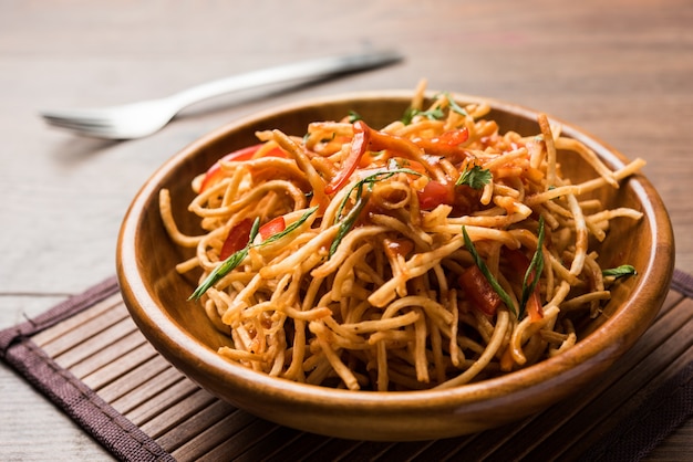 Chinese Bhel is a spicy indo-chinese recipe, served in a bowl. selective focus