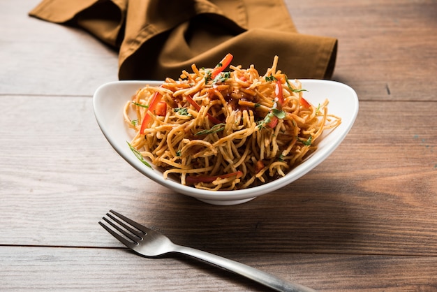 Chinese Bhel is a spicy indo-chinese recipe, served in a bowl. selective focus