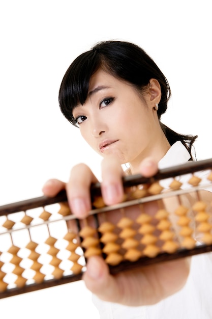 Chinese business woman holding traditional abacus on white background.