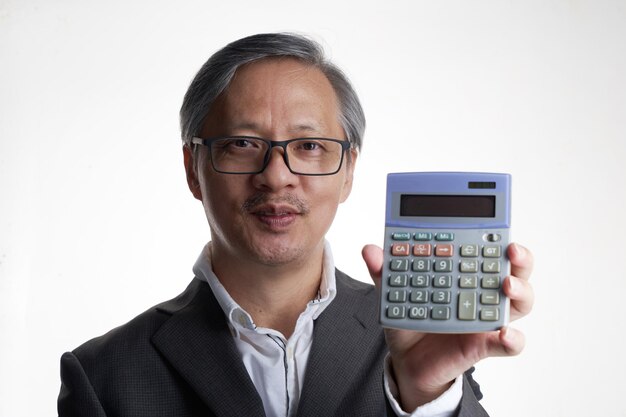 Chinese businessman holding a calculator with smile