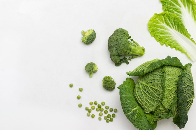 Chinese cabbage leaves and Savoy cabbage. Copy space. Flat lay. White background