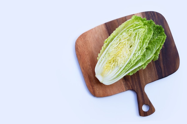 Chinese cabbage on wooden cutting board on white