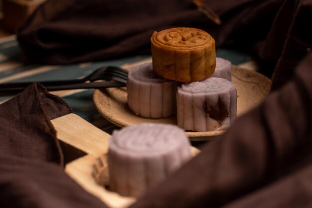 Chinese cakes are on the gray cloth of the wooden table