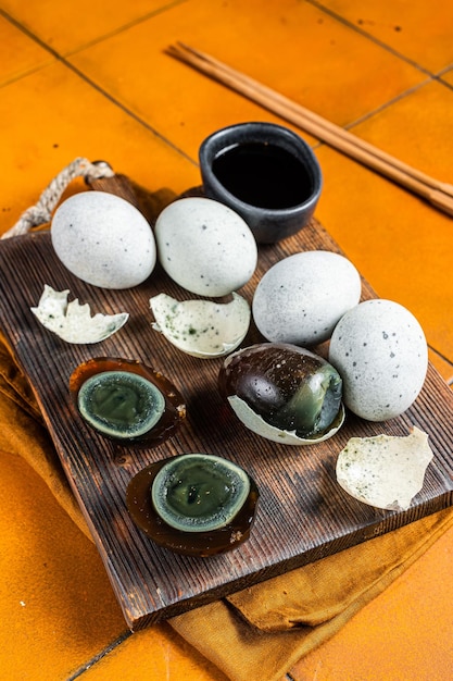 Chinese Century egg preserved duck eggs Orange background Top view