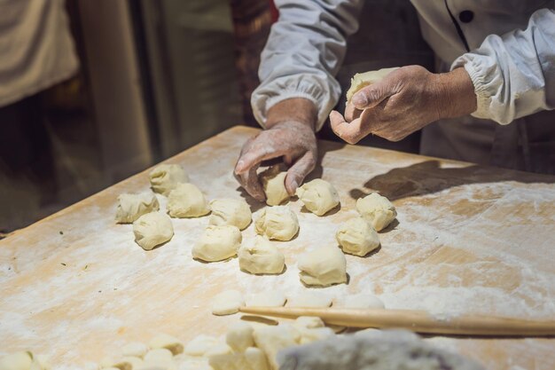 キッチンで餃子を作る中国人シェフ