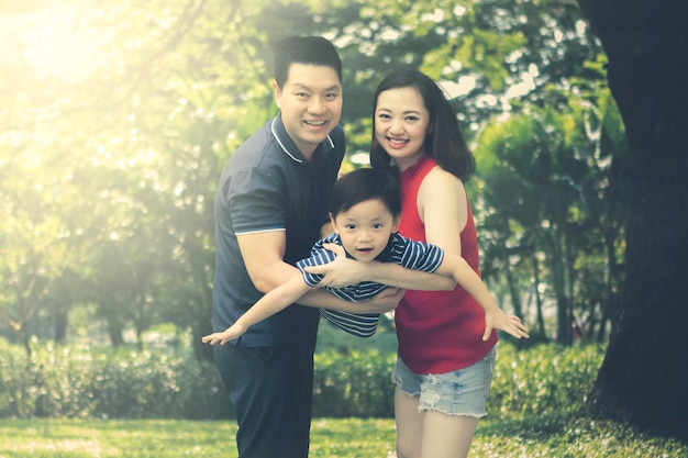 Chinese family swinging their son