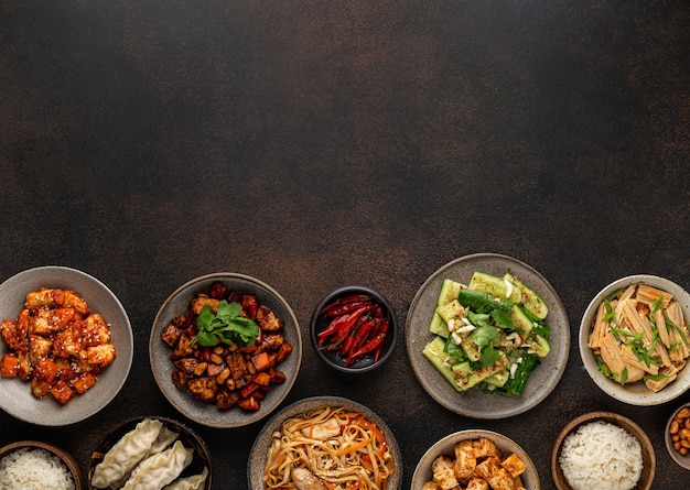 Chinese food, chinese traditional cuisine dishes on dark background, top view, copy space