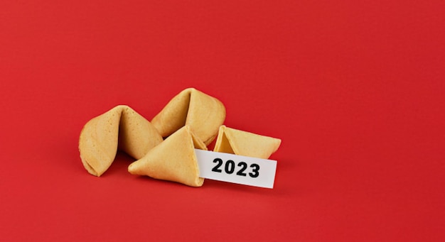 Chinese fortune cookies Cookies with white blank and 2023 text inside for prediction words Isolated on red background