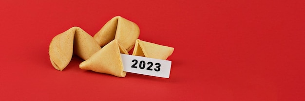 Chinese fortune cookies Cookies with white blank and 2023 text inside for prediction words Isolated on red background