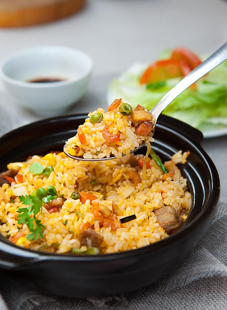 Chinese fried rice, salad, spice, bowls, and plates with food top view