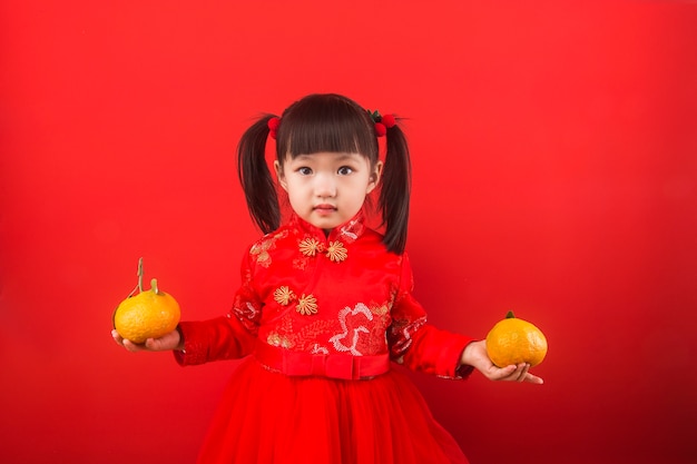 A chinese girl holding oranges for the spring festival