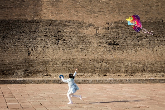 Chinese girl running kite, Pingyao, Shanxi, China