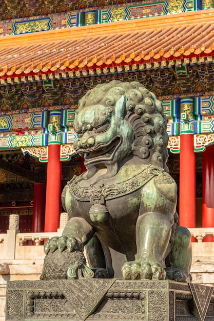 Chinese guardian lion or shishi statue from Ming dynasty era at the entrance to the palace in the Forbidden City Beijing China