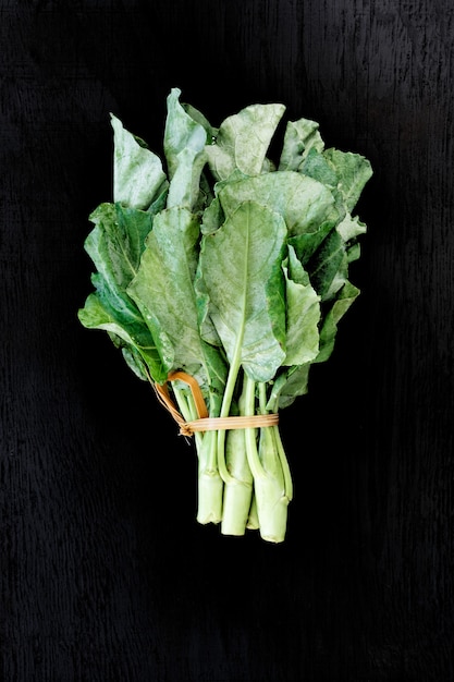 Chinese kale vegetable on the back wood background.