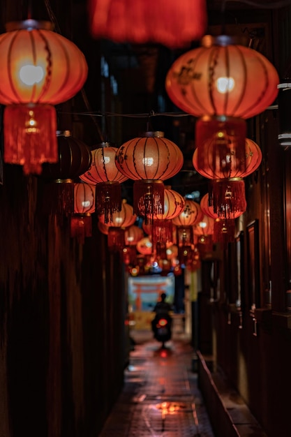 Chinese lanterns on the street at night, China town, Chinese new year decoration. Translation Happy