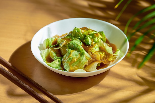 Chinese lettuce salad in oyster sauce and garlic in a white plate