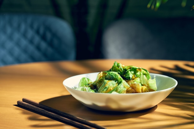 Chinese lettuce salad in oyster sauce and garlic in a white plate