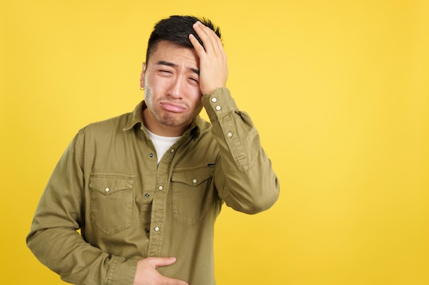 Chinese man gesturing bodily discomfort and headache