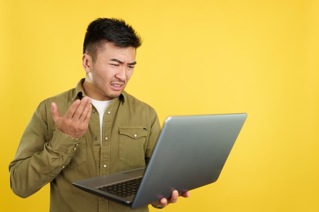 Chinese man having a problem with a laptop