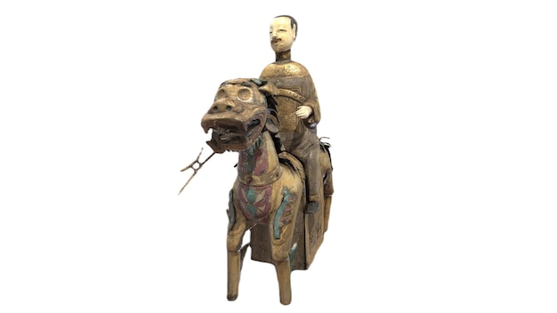 A chinese man riding a camel.
