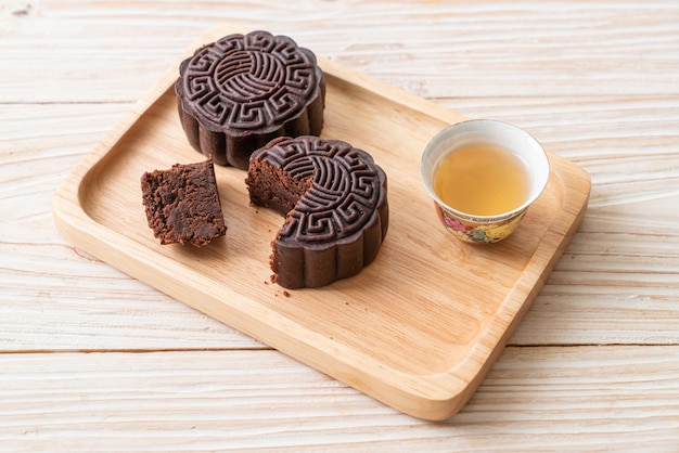 Chinese moon cake dark chocolate flavour on wood plate