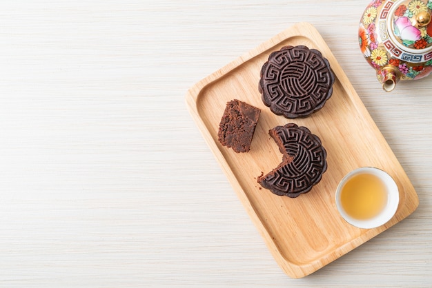 Chinese moon cake dark chocolate flavour on wood plate