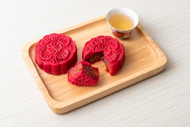 Chinese moon cake strawberry red bean flavour on wood plate