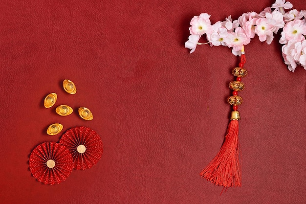 Chinese new year decoration with chinese good luck symbol gold ingots red paper fans and blossoms