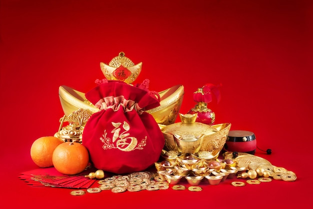 Chinese new year decorations, Gold Coins and money bag with character meaning, "luck riches healthy" on red background.