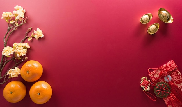 Chinese new year decorations made from red packet orange and\
gold ingots or golden lump chinese characters fu on the object\
means to fortune good luck wealth and money flow