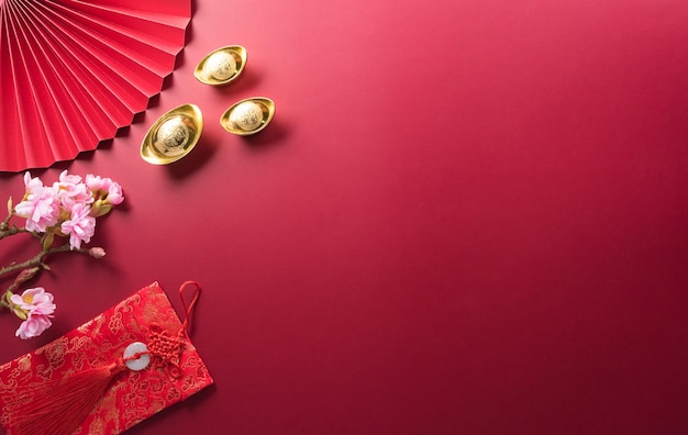 Chinese new year decorations made from red packet orange and gold ingots or golden lump Chinese characters on the object means to fortune good luck wealth and money flow