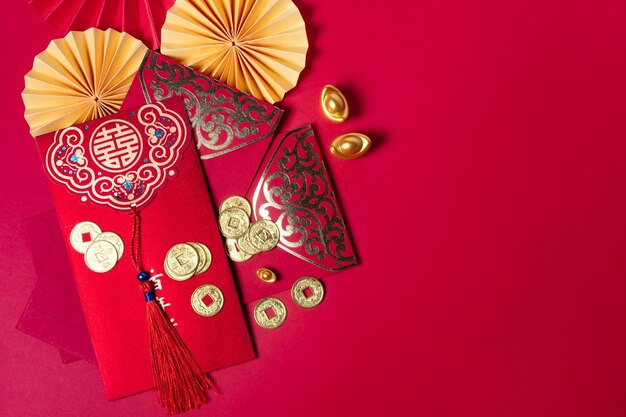 Photo chinese new year decorations with red background with assorted festival decorations top view