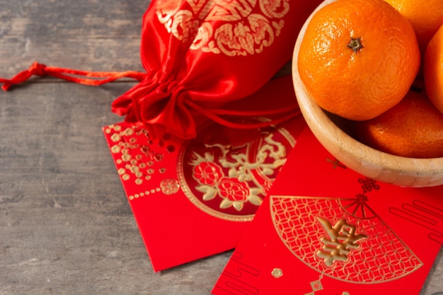 Chinese new year festival decorations and oranges on wooden background